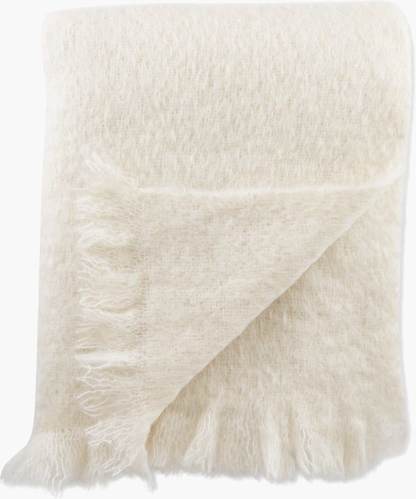White fluffy blanket with fringes on a white background